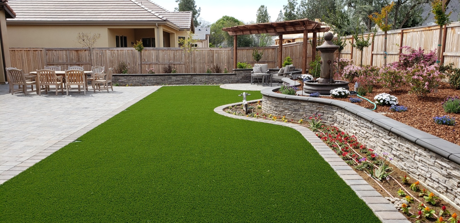 Turf lawn & stacked-stone wall